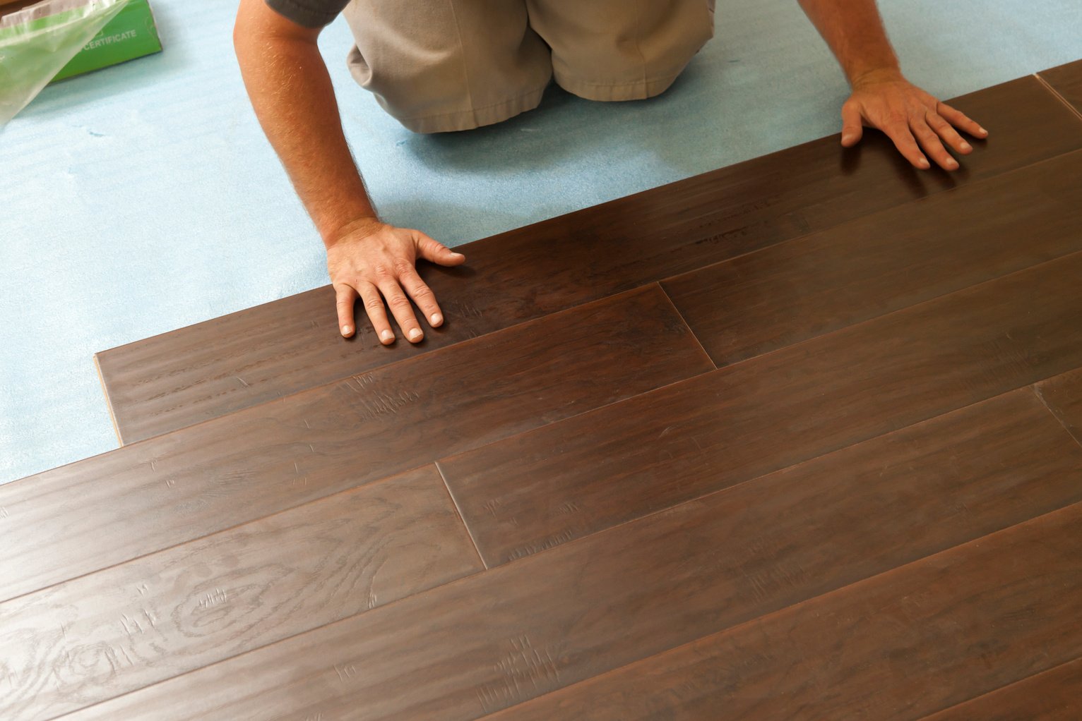 Man Installing New Laminate Wood Flooring